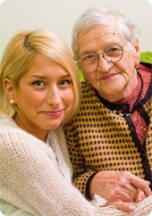 Young woman and older woman holding hands